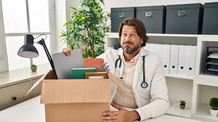 A man packing a box with medical items