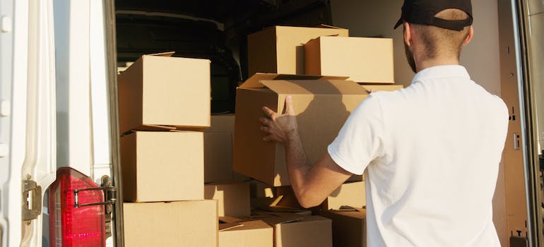 maryland long distance movers fixing boxes inside of a moving truck.