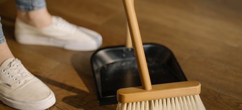 woman sweeping the floor after office decommissioning