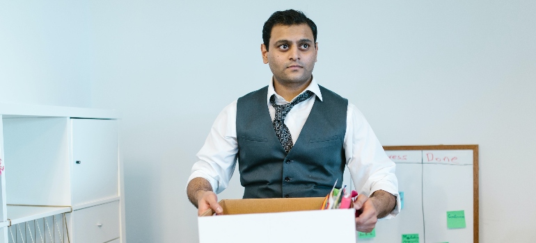 a man holding a box after office decommissioning 