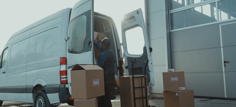 Long distance movers in Maryland loading boxes in a truck.