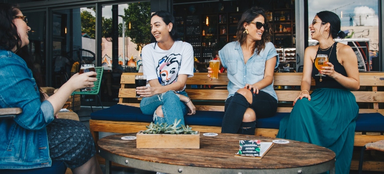 Four women talking in a bar