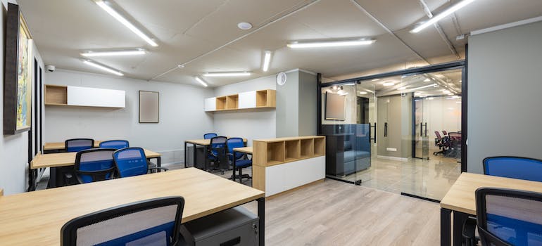 A modern office with glass doors and new furniture