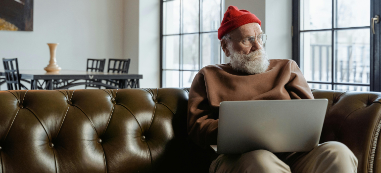 interior design tips for seniors: old person sitting on a couch with round and soft corners