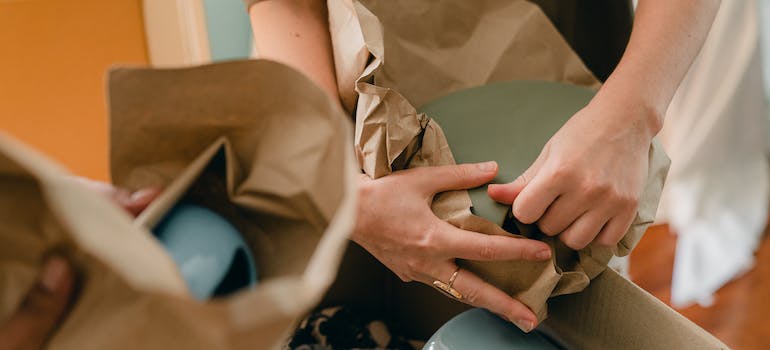 a person packing plates 