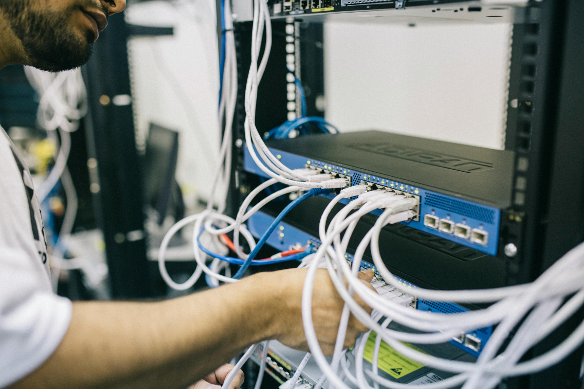 engineer fixing cables on a server