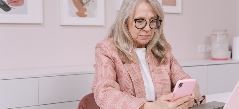 an elderly woman using her phone 