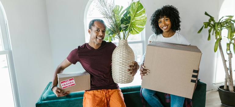 a couple holding boxes talking about understanding customs and regulations