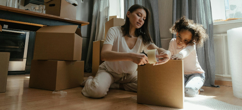 mother and daughter packing for a move