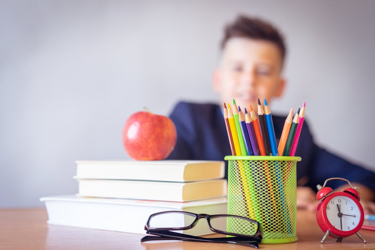 boy looking on a tidied desk representing the international moving with children