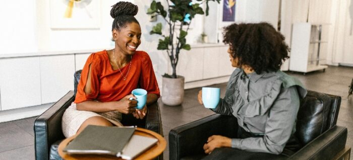 Women Sitting on the Chair while Having Conversation