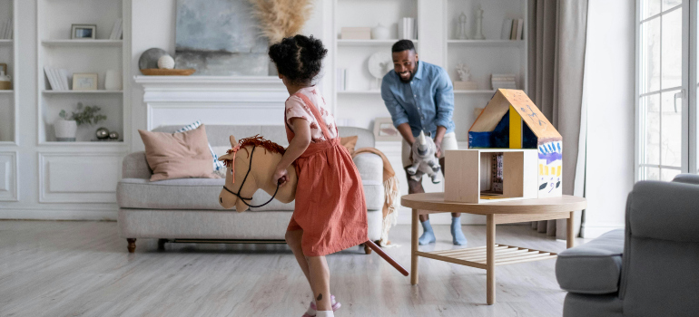 father and daughter playing in the living room