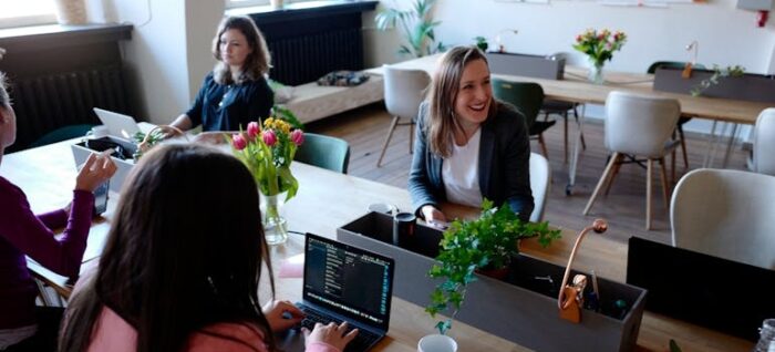 Woman Sitting on the Chair Using Laptop to research all about Short-Term vs. Long-Term International Employee Relocation Assignments