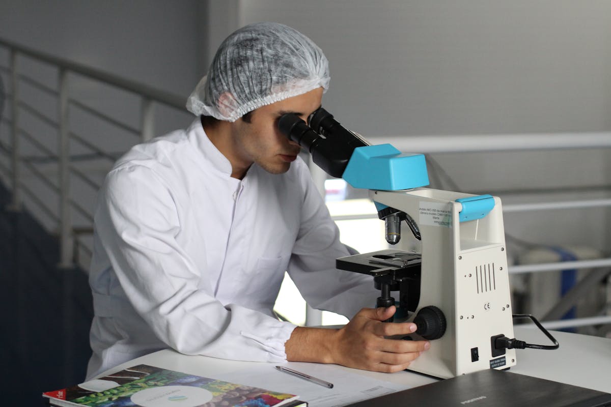 a lab tech using a microscope