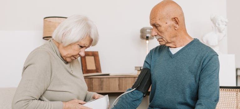 Woman Checking Blood Pressure of a Man