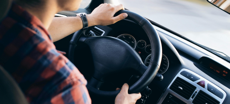 Person driving, reflecting the decision to ship or drive your car.