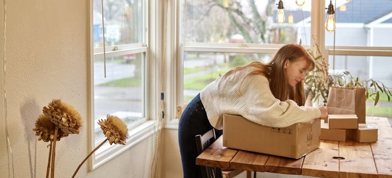 woman packing a box knows that fall is the perfect time to move in Washington DC