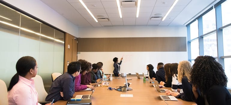 People having a meeting in a conference room talking about unexpected issues during business relocations 