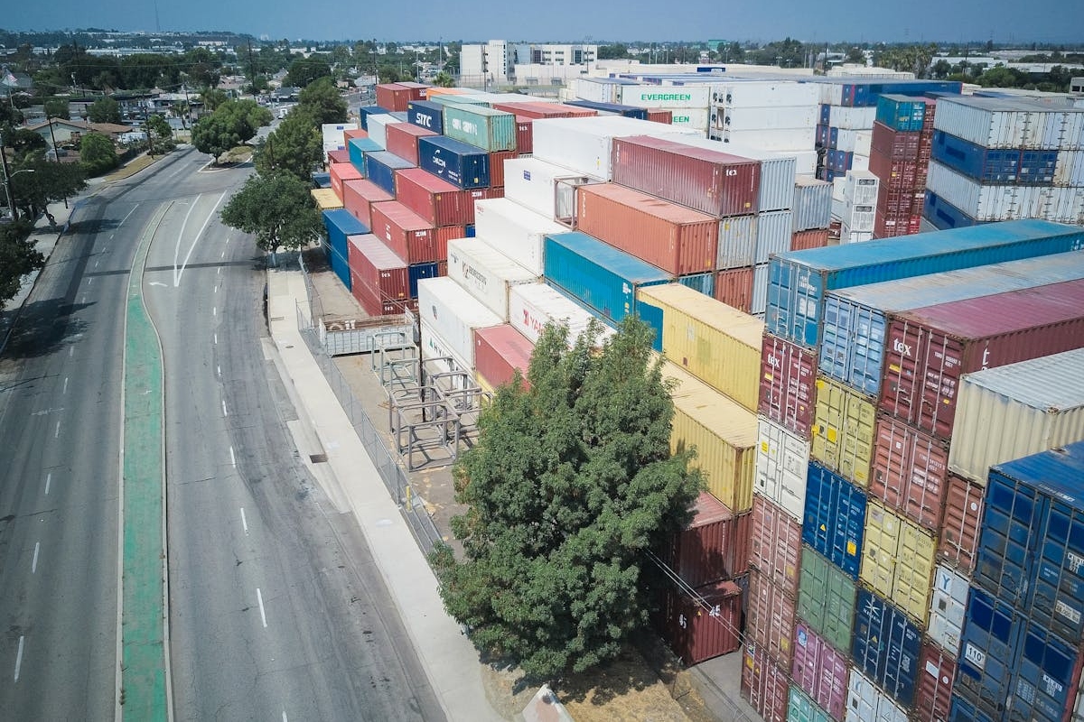 Piles of Shipping Containers along an Empty Road