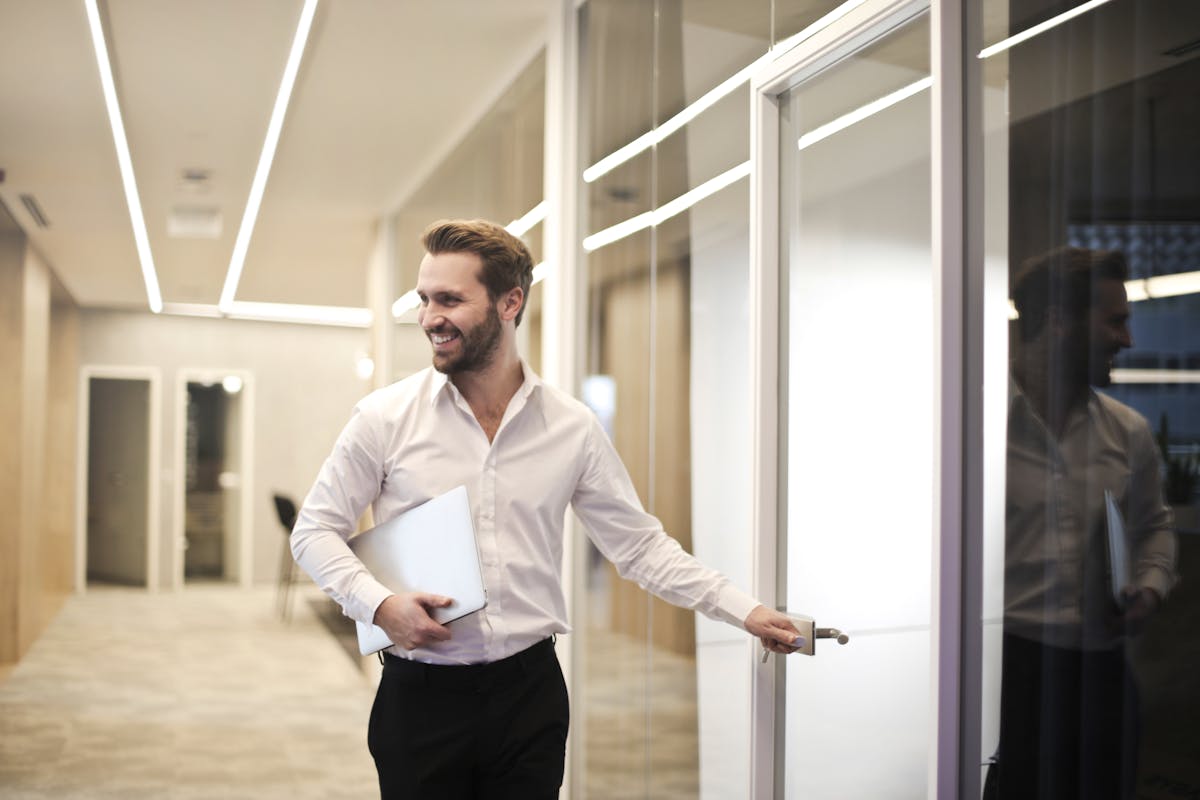 a man wearing a white shirt in a hallway